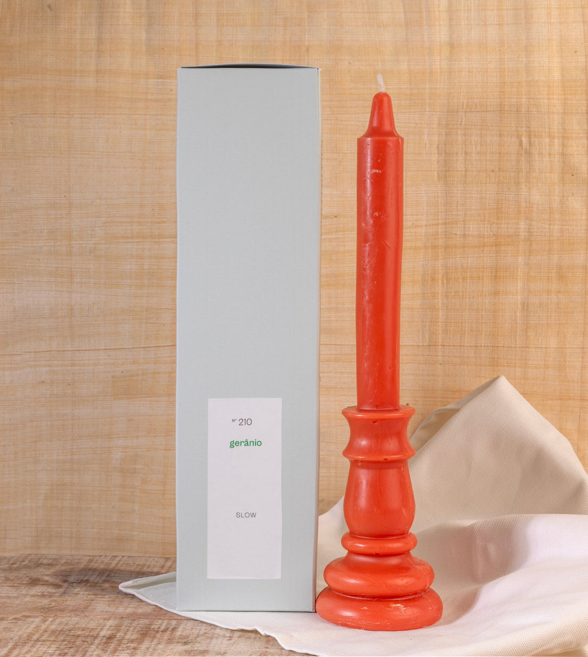 Vela castiçal decorativa cor de laranja da SLOW, aromatizada com óleo essencial de toranja com embalagem